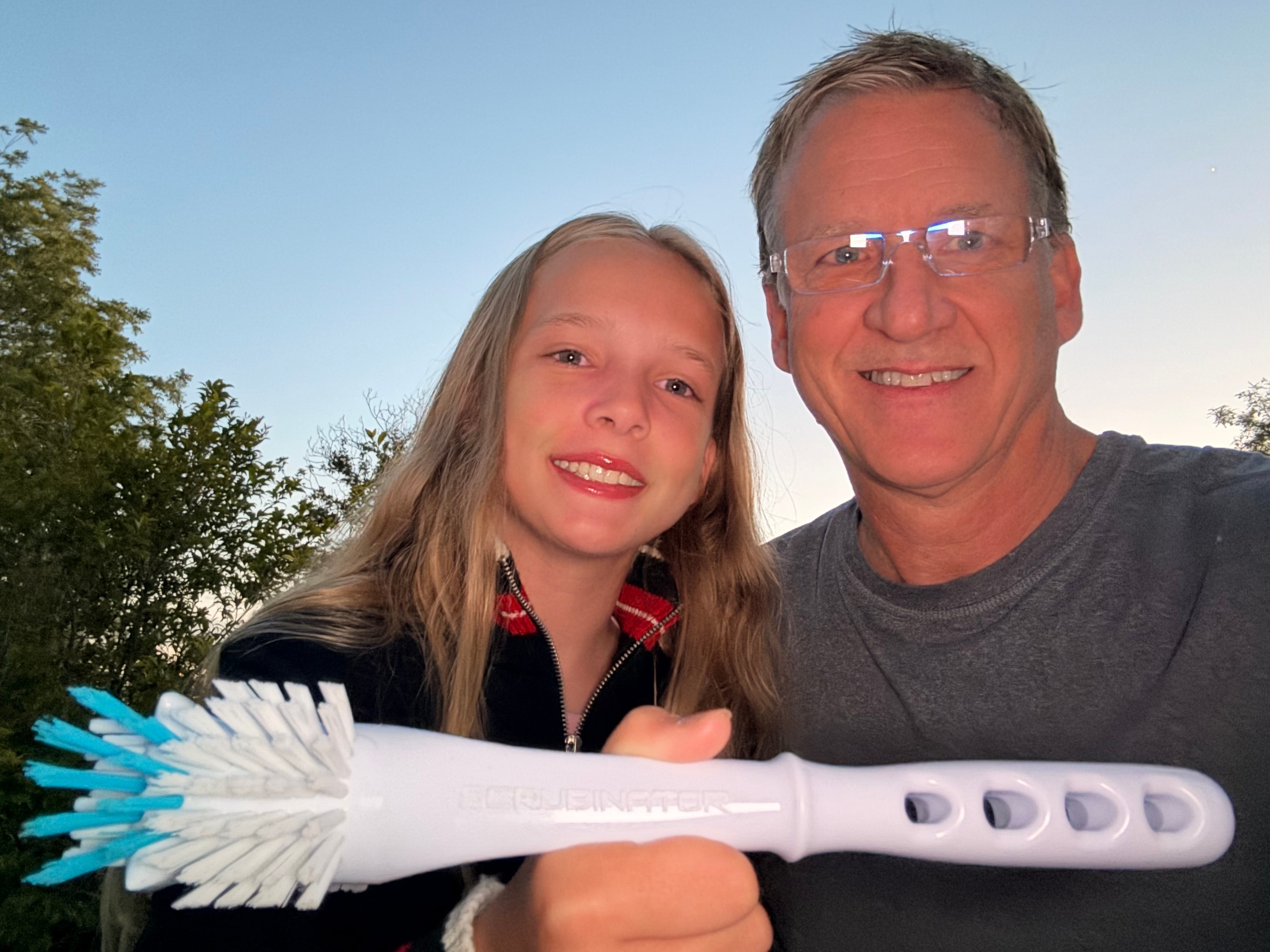 Scrubinator founders holding the 7-in-1 dish brush